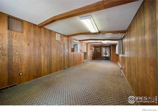 201 Howard St, Brush, CO 80723 - hall with wooden walls, beam ceiling, and carpet flooring