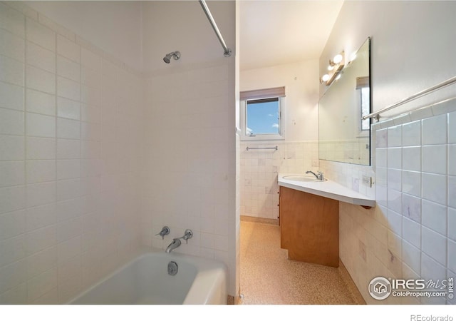 201 Howard St, Brush, CO 80723 - full bath featuring tile walls, vanity, and tub / shower combination
