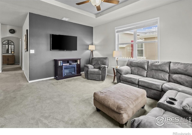 6150 Bluestem Grn, Frederick, CO 80530 - living room featuring carpet flooring, baseboards, a ceiling fan, and a tray ceiling