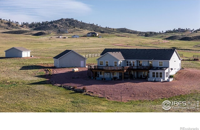 631 Linecamp Dr, Livermore, CO 80536 - back of house with a deck with mountain view, a view of rural / pastoral area, a lawn, and dirt driveway