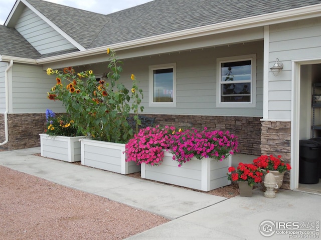 631 Linecamp Dr, Livermore, CO 80536 - view of home's exterior with stone siding and a shingled roof
