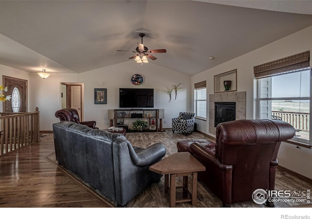 631 Linecamp Dr, Livermore, CO 80536 - living area featuring a tiled fireplace, wood finished floors, vaulted ceiling, a ceiling fan, and baseboards