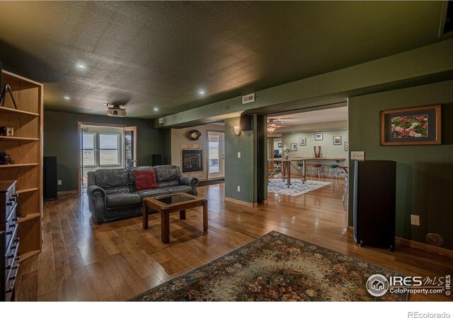 631 Linecamp Dr, Livermore, CO 80536 - living room with wood finished floors, recessed lighting, baseboards, and a textured ceiling