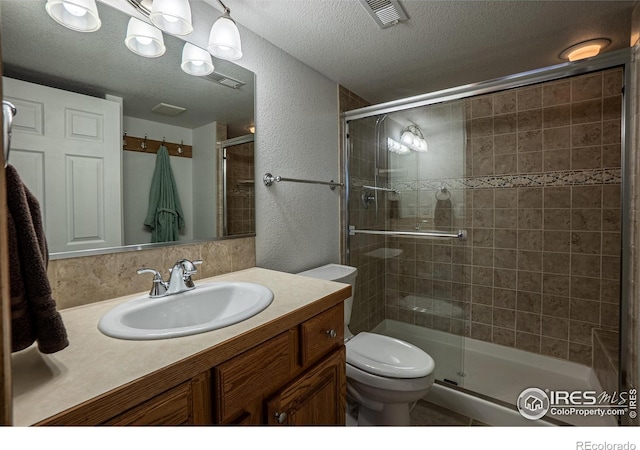 631 Linecamp Dr, Livermore, CO 80536 - bathroom with vanity, a shower stall, a textured ceiling, toilet, and a textured wall