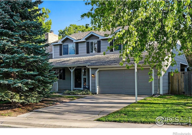 1359 Caledonia Cir, Louisville, CO 80027 - traditional-style home with concrete driveway, an attached garage, a chimney, roof with shingles, and covered porch