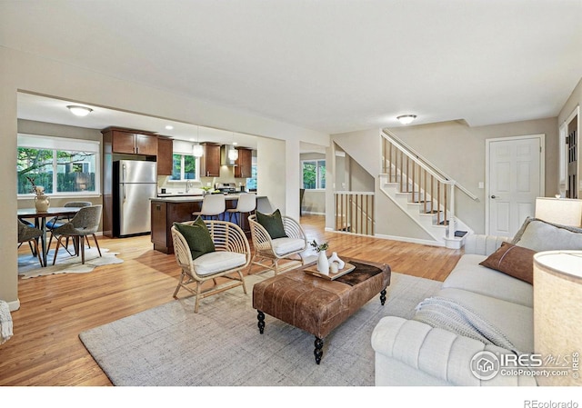1359 Caledonia Cir, Louisville, CO 80027 - living room featuring stairway and light wood-style floors