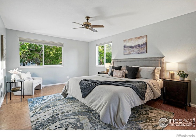 1359 Caledonia Cir, Louisville, CO 80027 - bedroom with baseboards, wood finished floors, and a ceiling fan