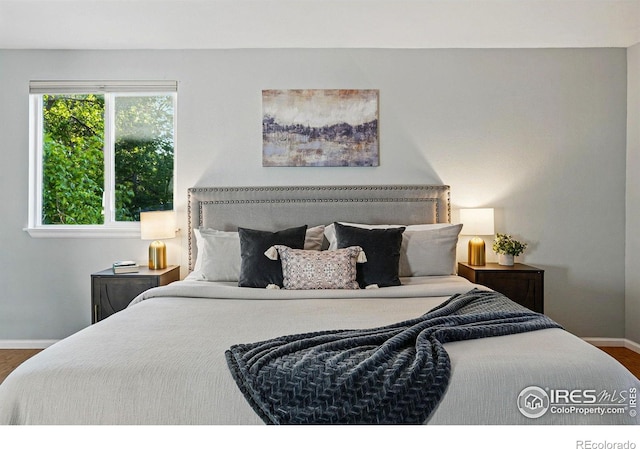 1359 Caledonia Cir, Louisville, CO 80027 - bedroom featuring baseboards and wood finished floors