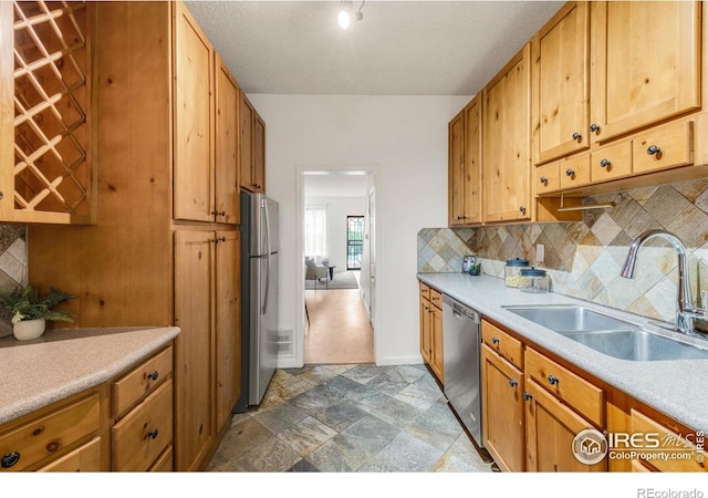 135 E 8th Ave, Denver, CO 80203 - kitchen featuring a sink, appliances with stainless steel finishes, backsplash, baseboards, and a textured ceiling