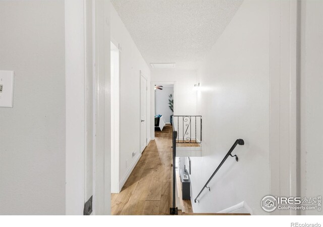 135 E 8th Ave, Denver, CO 80203 - hall with an upstairs landing, a textured ceiling, and light wood-style flooring