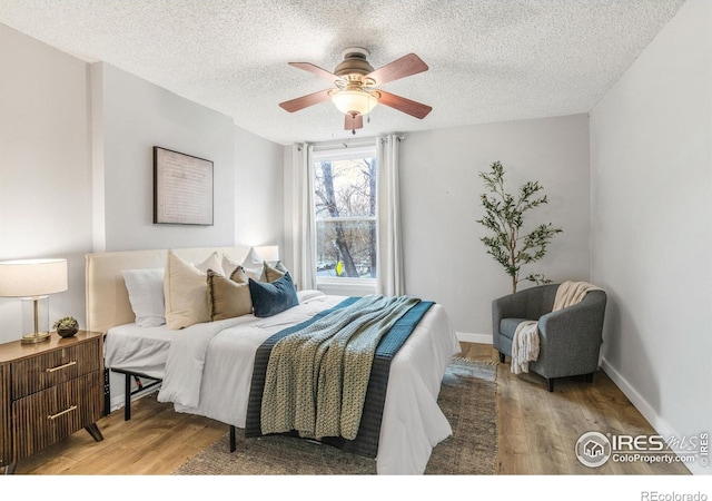 135 E 8th Ave, Denver, CO 80203 - bedroom featuring light wood-type flooring, a textured ceiling, a ceiling fan, and baseboards