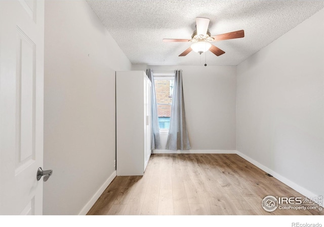 135 E 8th Ave, Denver, CO 80203 - empty room with a textured ceiling, light wood finished floors, a ceiling fan, and baseboards