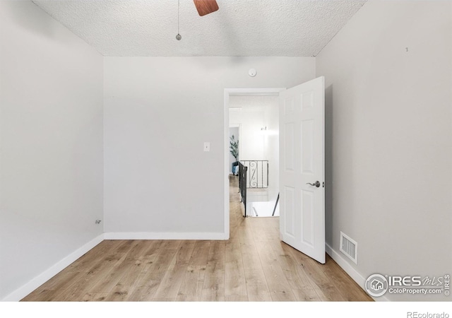 135 E 8th Ave, Denver, CO 80203 - spare room with a textured ceiling, light wood-type flooring, baseboards, and ceiling fan