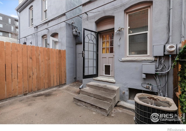 135 E 8th Ave, Denver, CO 80203 - doorway to property featuring central AC unit and stucco siding