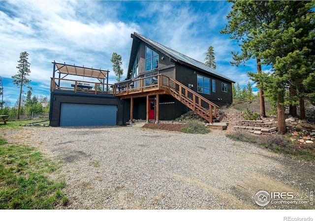 61 County Road 8501, Tabernash, CO 80478 - view of front facade with a wooden deck, stairs, and gravel driveway