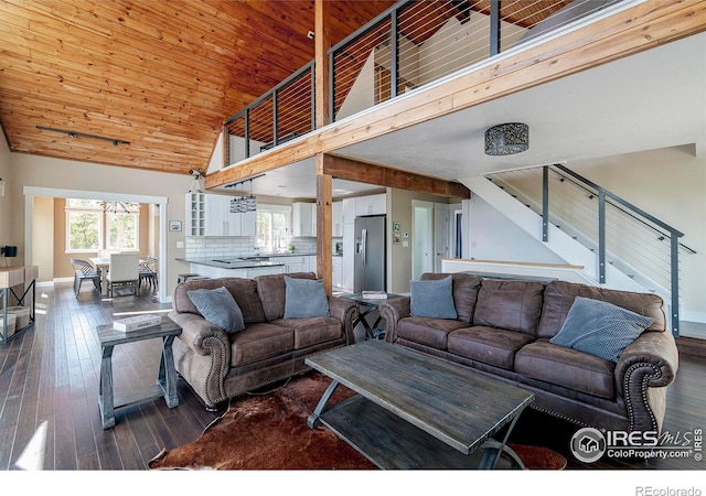 61 County Road 8501, Tabernash, CO 80478 - living room featuring high vaulted ceiling, baseboards, hardwood / wood-style floors, stairway, and wooden ceiling
