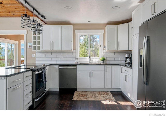 61 County Road 8501, Tabernash, CO 80478 - kitchen featuring stainless steel appliances, a peninsula, a sink, dark wood-style flooring, and recessed lighting