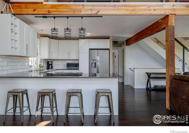 61 County Road 8501, Tabernash, CO 80478 - kitchen with stainless steel appliances, open shelves, dark wood-style floors, and dark countertops