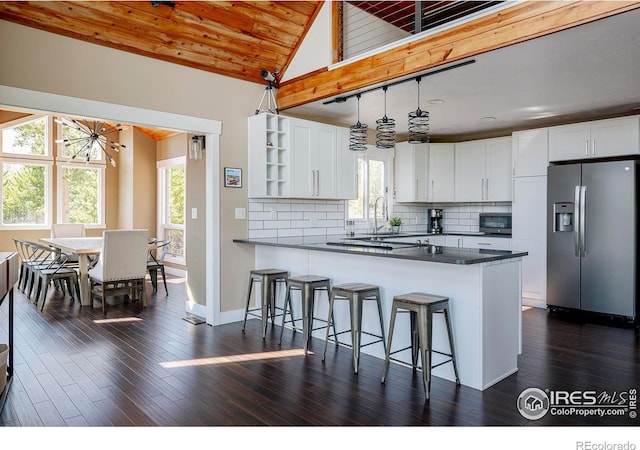 61 County Road 8501, Tabernash, CO 80478 - kitchen with stainless steel appliances, dark countertops, healthy amount of natural light, open shelves, and wood ceiling