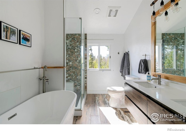 61 County Road 8501, Tabernash, CO 80478 - full bathroom featuring a freestanding bath, a stall shower, double vanity, toilet, and wood finished floors