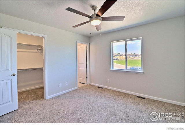 4312 Rockcress Rd, Evans, CO 80620 - unfurnished bedroom featuring carpet flooring, a spacious closet, baseboards, ceiling fan, and a textured ceiling