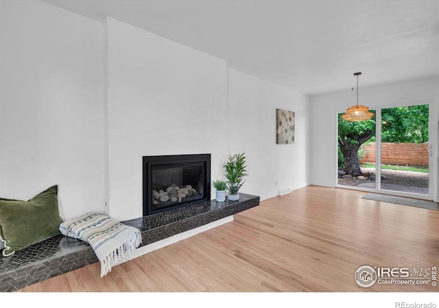 4658 Ingram Ct, Boulder, CO 80305 - unfurnished living room featuring wood finished floors and a glass covered fireplace