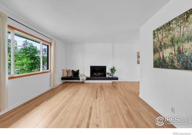 4658 Ingram Ct, Boulder, CO 80305 - unfurnished living room with wood finished floors, a fireplace with raised hearth, and baseboards