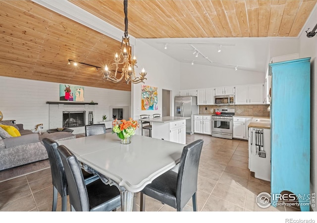 1921 Glenview Ct, Berthoud, CO 80513 - dining room featuring wood ceiling, track lighting, light tile patterned floors, a chandelier, and high vaulted ceiling