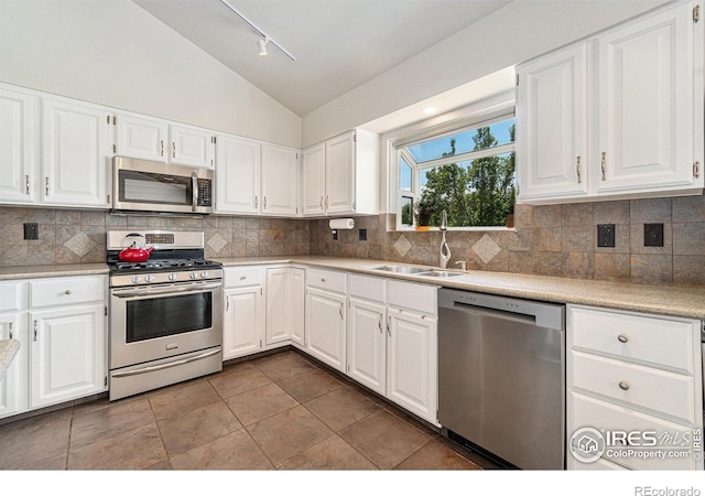 1921 Glenview Ct, Berthoud, CO 80513 - kitchen featuring appliances with stainless steel finishes, a sink, vaulted ceiling, track lighting, and light countertops