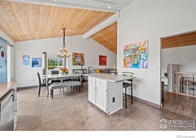 1921 Glenview Ct, Berthoud, CO 80513 - kitchen with light countertops, white cabinetry, lofted ceiling, light tile patterned floors, and a chandelier