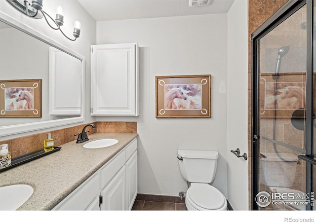 1921 Glenview Ct, Berthoud, CO 80513 - bathroom featuring double vanity, a shower stall, tile patterned floors, and toilet