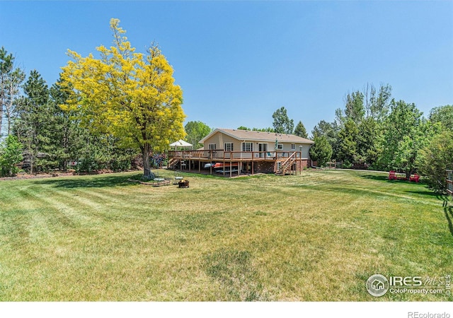 1921 Glenview Ct, Berthoud, CO 80513 - view of green lawn with a deck and stairway