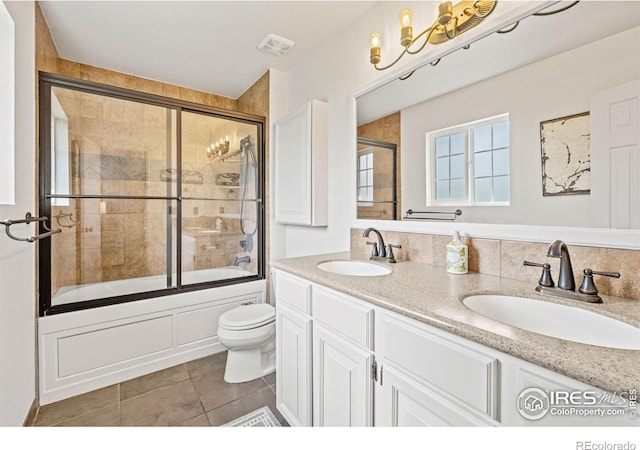 1921 Glenview Ct, Berthoud, CO 80513 - full bath with toilet, double vanity, combined bath / shower with glass door, and tile patterned flooring