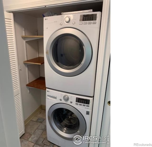 4775 White Rock Cir Unit B, Boulder, CO 80301 - laundry room with stacked washer / dryer, light stone finish flooring, and baseboards