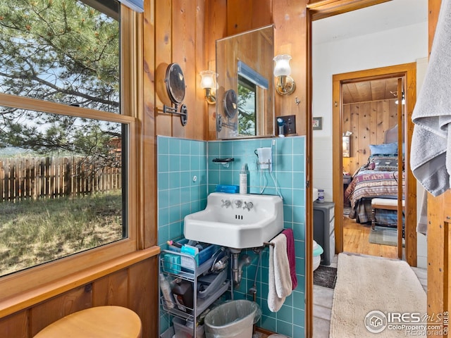 656 Halbach Ln, Estes Park, CO 80517 - ensuite bathroom featuring tile walls, a sink, and wooden walls