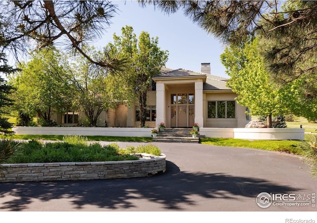 160 Ponderosa Dr, Boulder, CO 80303 - view of front of home with a chimney, stucco siding, and a tile roof