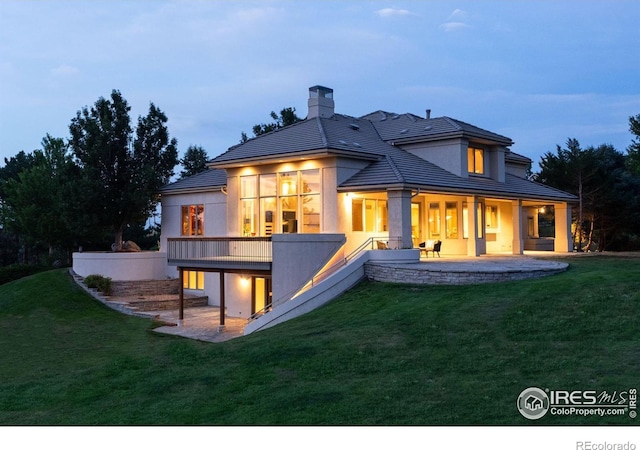 160 Ponderosa Dr, Boulder, CO 80303 - rear view of house featuring a yard, a patio area, a chimney, and stucco siding