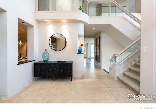 160 Ponderosa Dr, Boulder, CO 80303 - entrance foyer with a high ceiling, stairway, baseboards, and tile patterned flooring