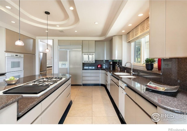 160 Ponderosa Dr, Boulder, CO 80303 - kitchen with built in appliances, a tray ceiling, a sink, backsplash, and recessed lighting