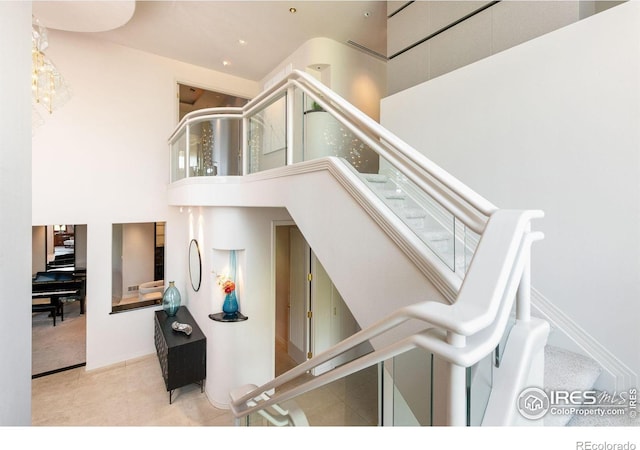 160 Ponderosa Dr, Boulder, CO 80303 - staircase featuring a towering ceiling and tile patterned flooring