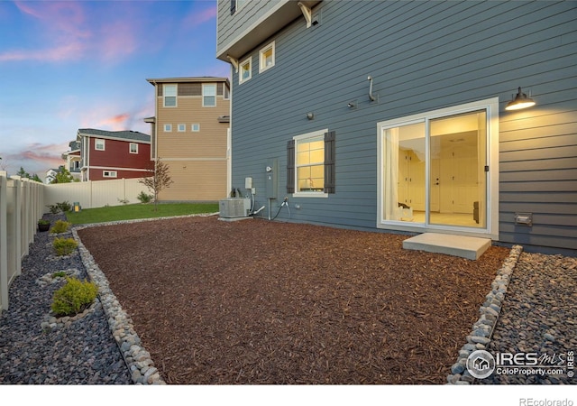 542 Highlands Cir, Erie, CO 80516 - back of property at dusk featuring a fenced backyard