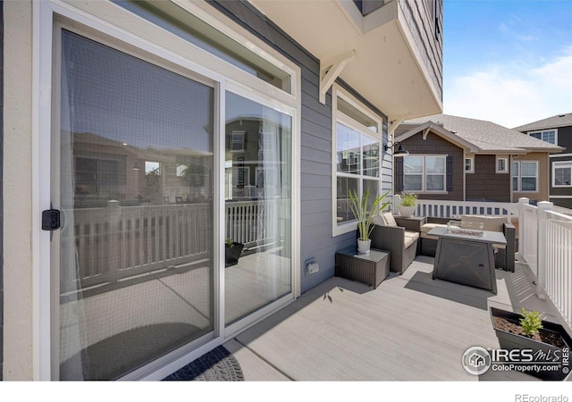 542 Highlands Cir, Erie, CO 80516 - view of wooden balcony featuring a wooden deck and an outdoor living space with a fire pit
