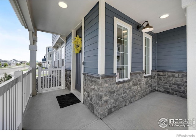 542 Highlands Cir, Erie, CO 80516 - property entrance with covered porch and stone siding