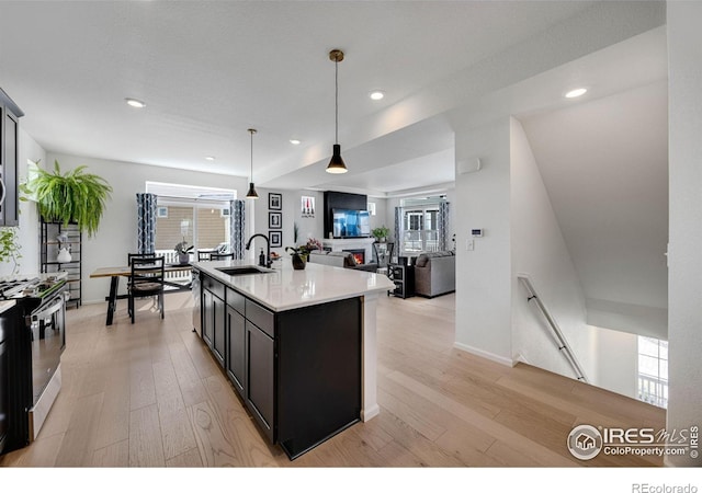 542 Highlands Cir, Erie, CO 80516 - kitchen with stove, light wood finished floors, light countertops, healthy amount of natural light, and recessed lighting