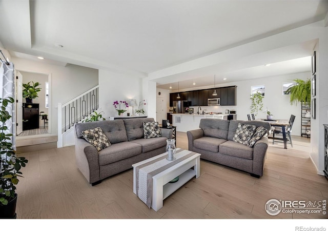 542 Highlands Cir, Erie, CO 80516 - living room featuring light wood finished floors, stairway, and recessed lighting