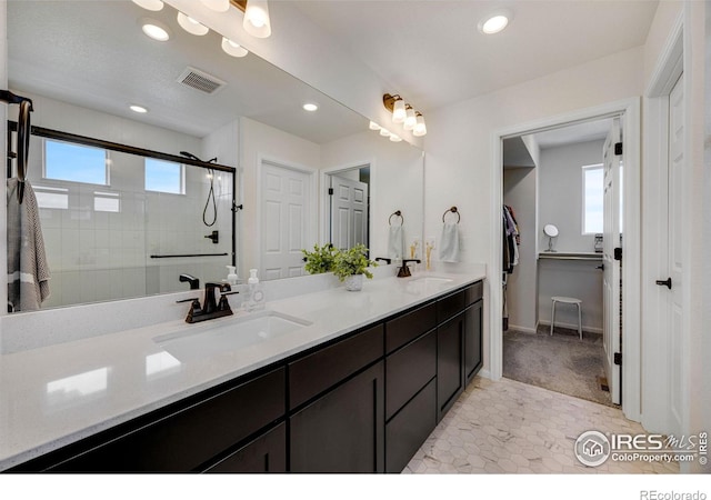 542 Highlands Cir, Erie, CO 80516 - full bathroom featuring double vanity, a stall shower, recessed lighting, and a spacious closet