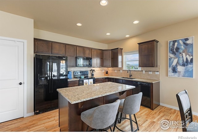 3802 Eucalyptus St, Wellington, CO 80549 - kitchen featuring black appliances, a sink, dark brown cabinets, light wood finished floors, and recessed lighting