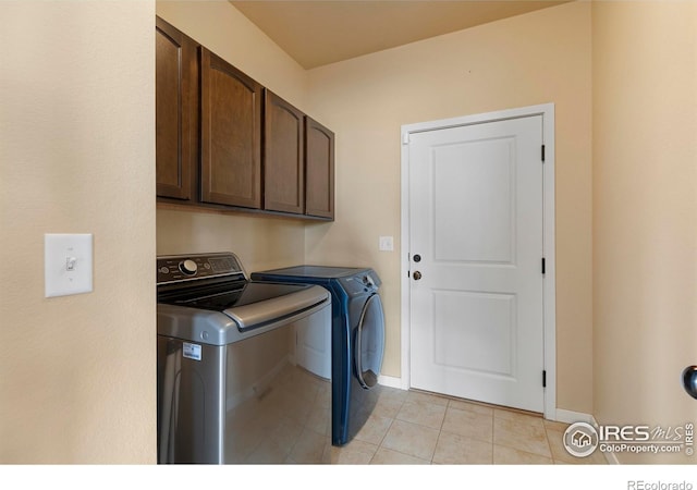 3802 Eucalyptus St, Wellington, CO 80549 - laundry room with washing machine and dryer, cabinet space, light tile patterned flooring, and baseboards