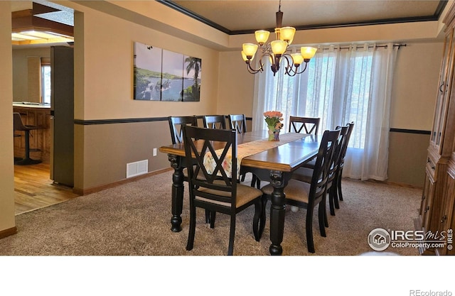 2152 45th Ave, Greeley, CO 80634 - carpeted dining area with a chandelier, healthy amount of natural light, ornamental molding, and baseboards