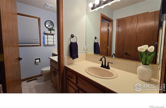 2152 45th Ave, Greeley, CO 80634 - bathroom featuring vanity, toilet, baseboards, and tile patterned floors